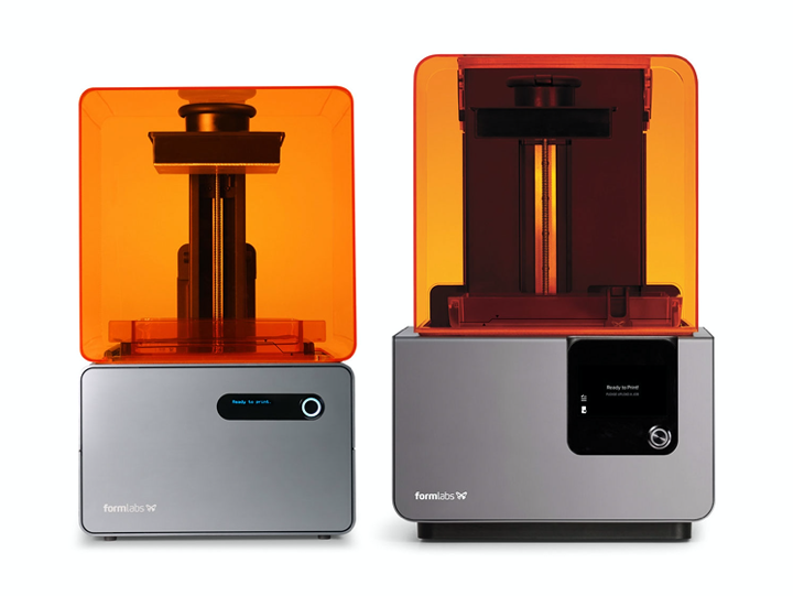 Image of formlabs printer.  Orange plastic cover on top with silver metal base and a black power button.